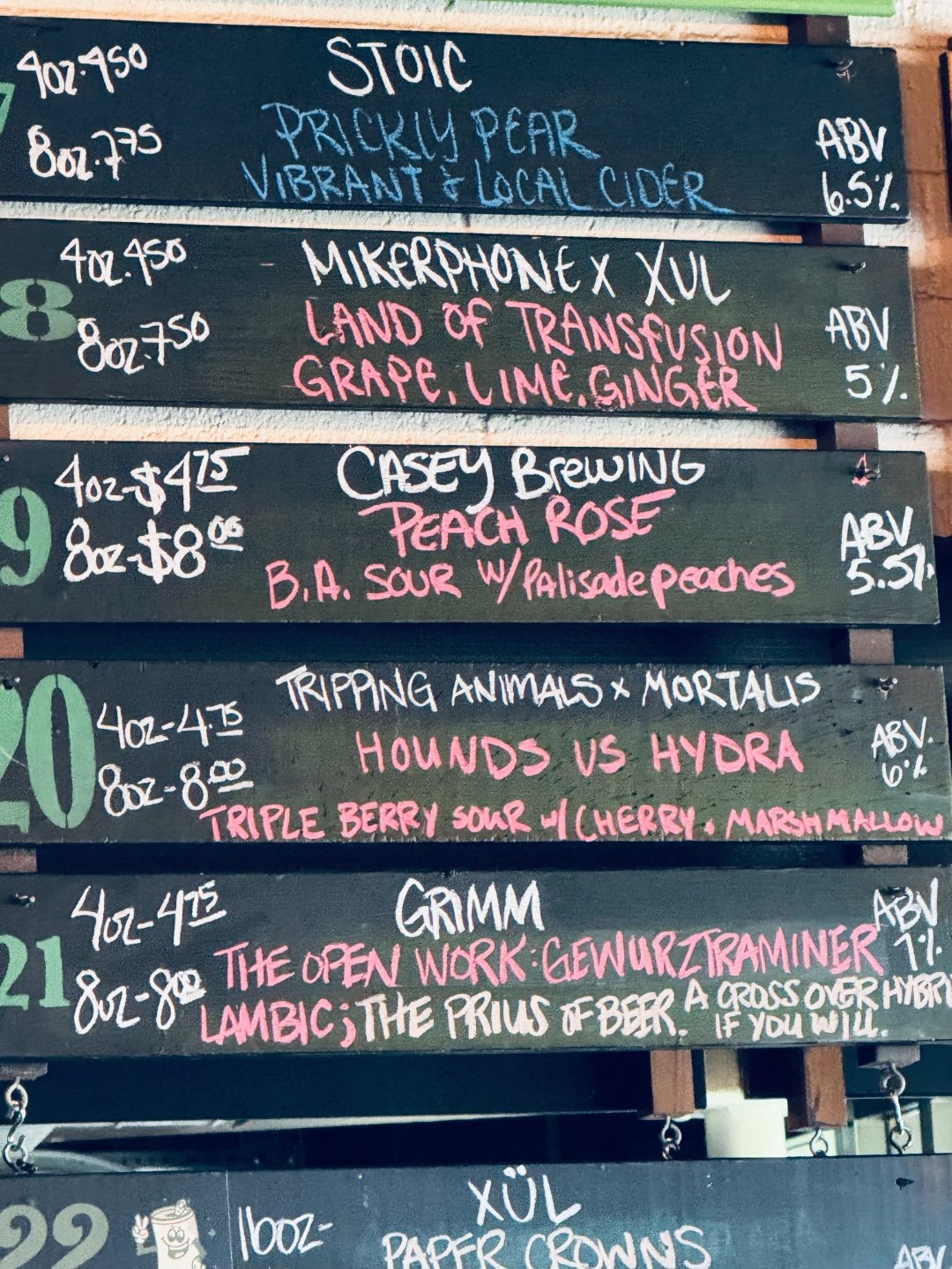 Close-up of chalkboard beer boards at The Wandering Tortoise showing tap 20: Tripping Animals x Mortalis, Hounds vs Hydra, Triple Berry Sour with Cherry and Marshmallow.